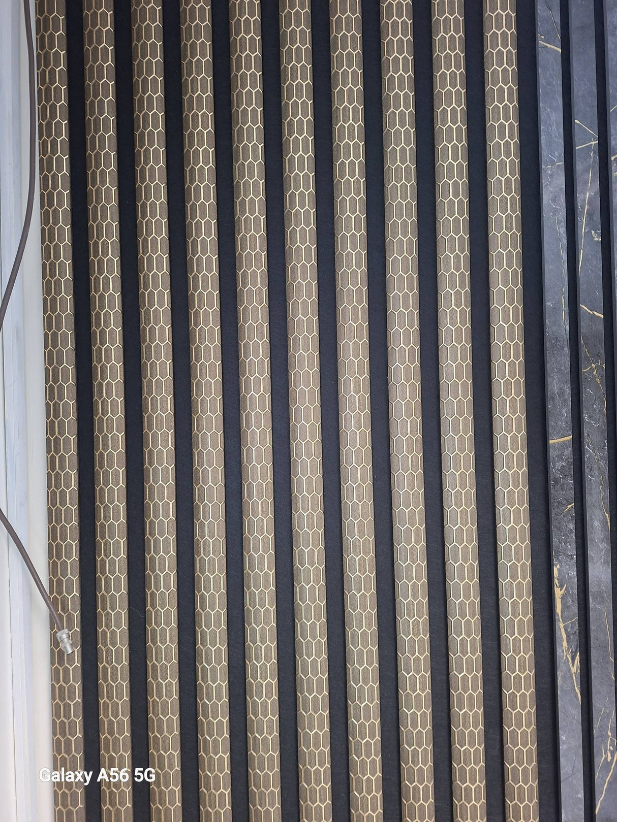 Dark oak honeycomb acoustic panel by Fairmont Home Interiors, 60x240cm, showcasing modern sound-absorbing wall panel design.
