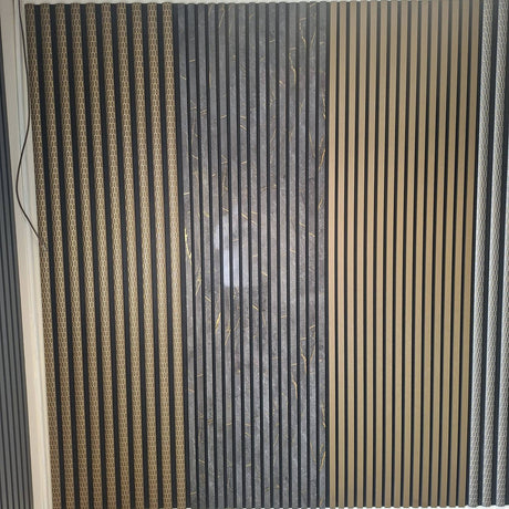 A wall-mounted decorative slatted panel with vertical wood-look and dark textured stripes, installed in a room with a white ceiling and gray floor. A small 'Galaxy A56 5G' watermark is visible at the bottom left.