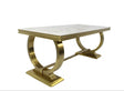 Dining table with marble top and gold metal base on a white background