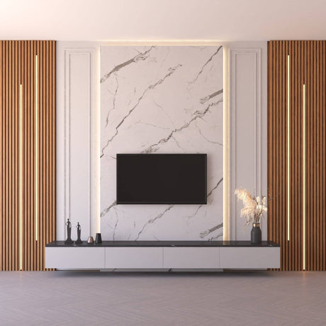 Modern living room wall featuring a large white marble-look panel with gray veining, flanked by warm wood slat panels with vertical LED lighting. A black flat-screen TV is mounted in the center above a low white media console.